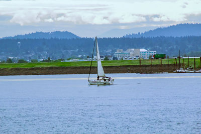 Sailboat in sea against sky