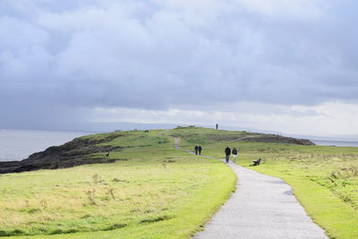 Tourists walking on rural road