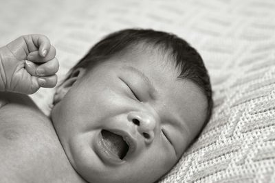 Close-up of cute newborn baby girl yawning