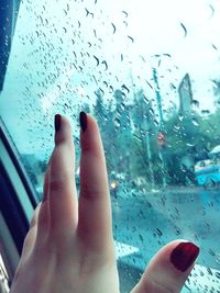 Low section of bare feet on glass window