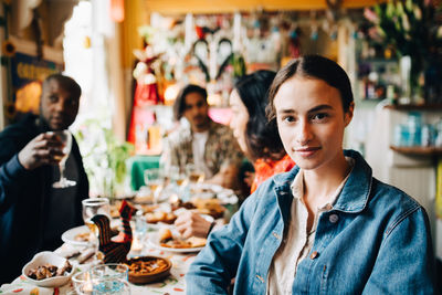 Portrait of friends sitting in restaurant