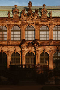 Low angle view of old building against sunset sky