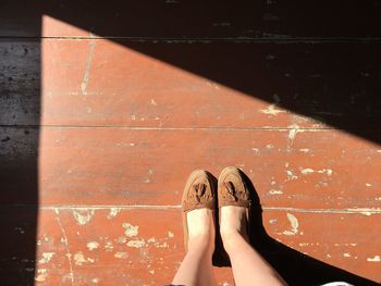 Low section of woman on wooden floor