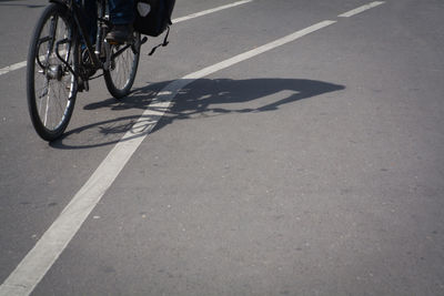 Low section of man riding bicycle on street