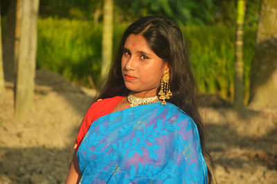 Portrait of beautiful woman standing on land