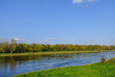 Scenic view of lake against blue sky