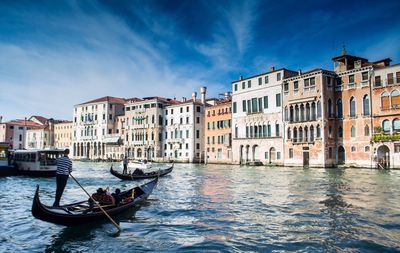 Gondola on grand canal by residential buildings