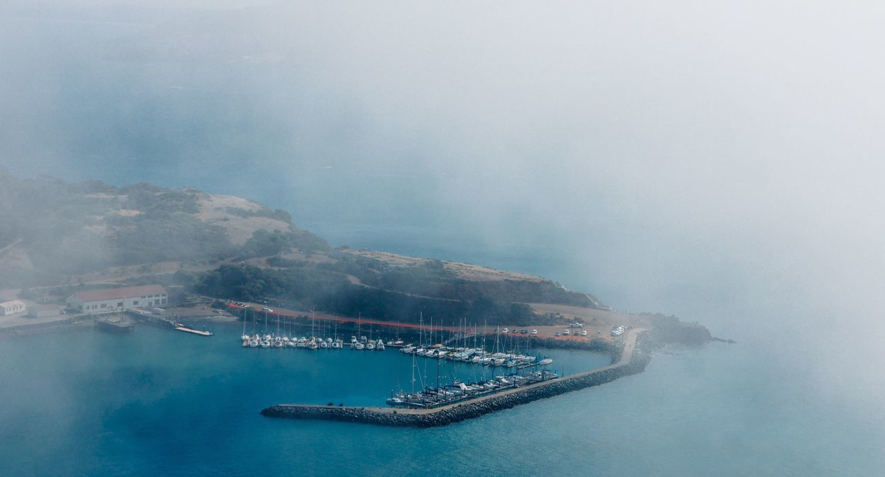 water, transportation, nautical vessel, waterfront, sea, mode of transport, boat, scenics, tranquility, tranquil scene, nature, sky, fog, beauty in nature, travel, copy space, outdoors, no people, idyllic, day