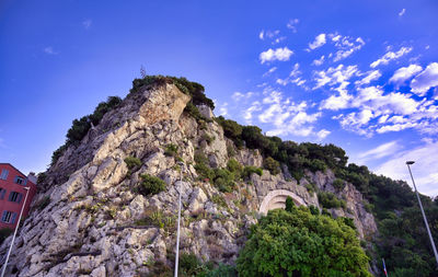Low angle view of cliff against sky