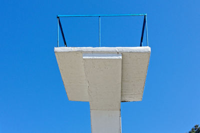 Low angle view of metallic structure against blue sky