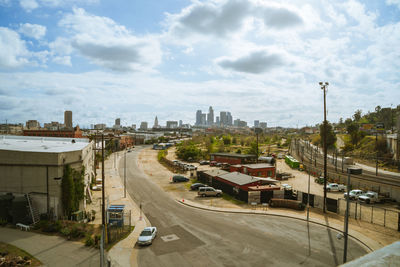 High angle view of street amidst buildings against sky