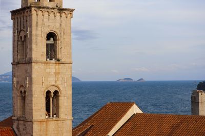 Building by sea against sky