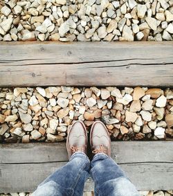 Low section of man standing on railroad track