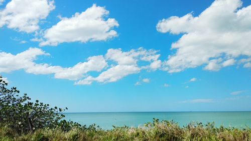 Scenic view of sea against blue sky