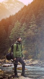 Full length of young man standing in forest