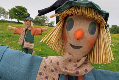 Scarecrows on field