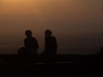 Silhouette of people at sunset