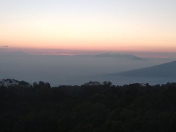 Scenic view of silhouette mountains against sky at sunset