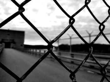 Close-up of chainlink fence against sky