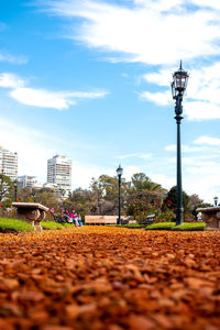 Street light by building against sky