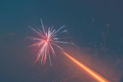 Low angle view of firework display at night