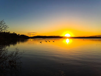 Scenic view of lake at sunset