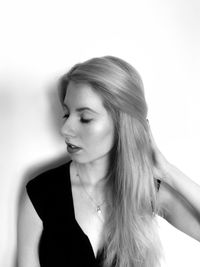 Close-up of young woman against white background