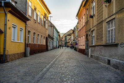 Empty alley amidst buildings in city