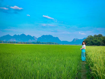 Man standing on field against sky