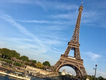 Low angle view of eiffel tower against cloudy sky