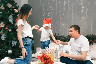 Side view of mother and daughter sitting on table