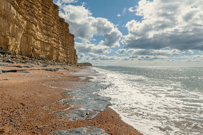 View of beach against cloudy sky