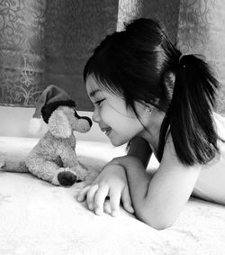 Close-up of girl playing with toy animal on floor