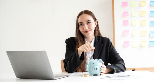 Businesswoman using laptop at office
