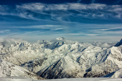 Scenic view of snow covered mountains against sky