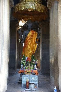 Statue of people in temple outside building