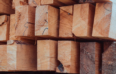 Stacks of cut wooden bars. composition of lumber. wooden background