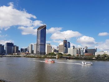 City by river against sky