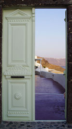 Closed door of building against sky