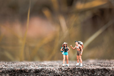 Figurines of hikers on walkway