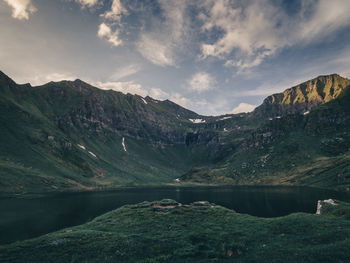 Scenic view of lake and mountains against sky