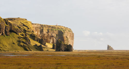 View of rock formations on landscape against sky