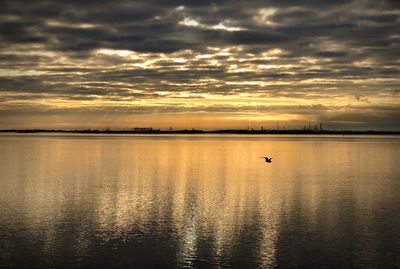 Scenic view of lake against sky during sunset