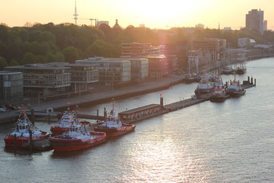 Boats in river at sunset