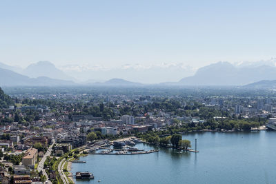 High angle view of townscape by mountains against clear sky