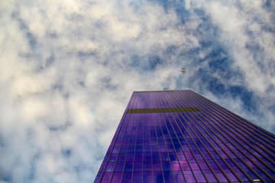 Low angle view of modern building against cloudy sky