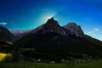 Scenic view of mountains against blue sky