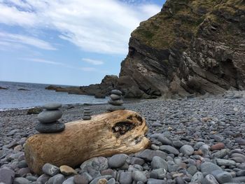 Rocks on beach against sky