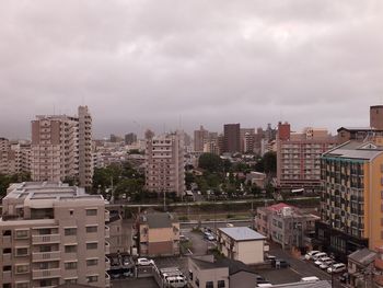 High angle view of buildings in city against sky