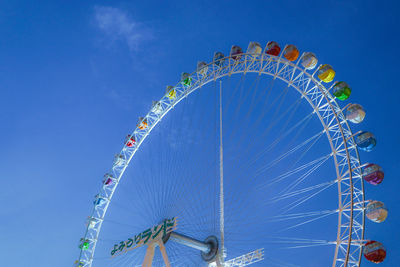 Low angle view of ferris wheel against clear sky